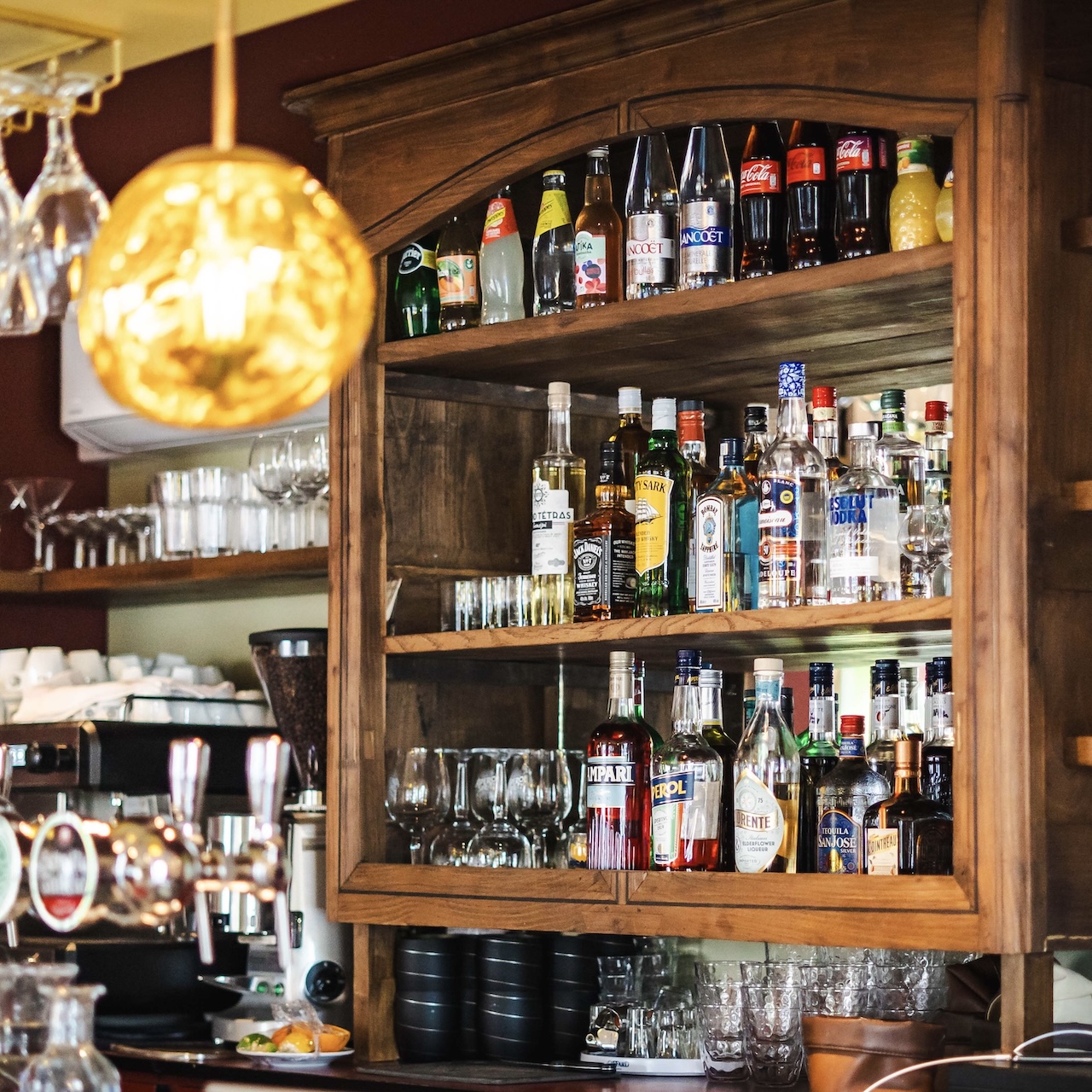 Détail de l’arrière-bar en bois récupéré avec miroir ancien et tablette, pour le restaurant MEIGA