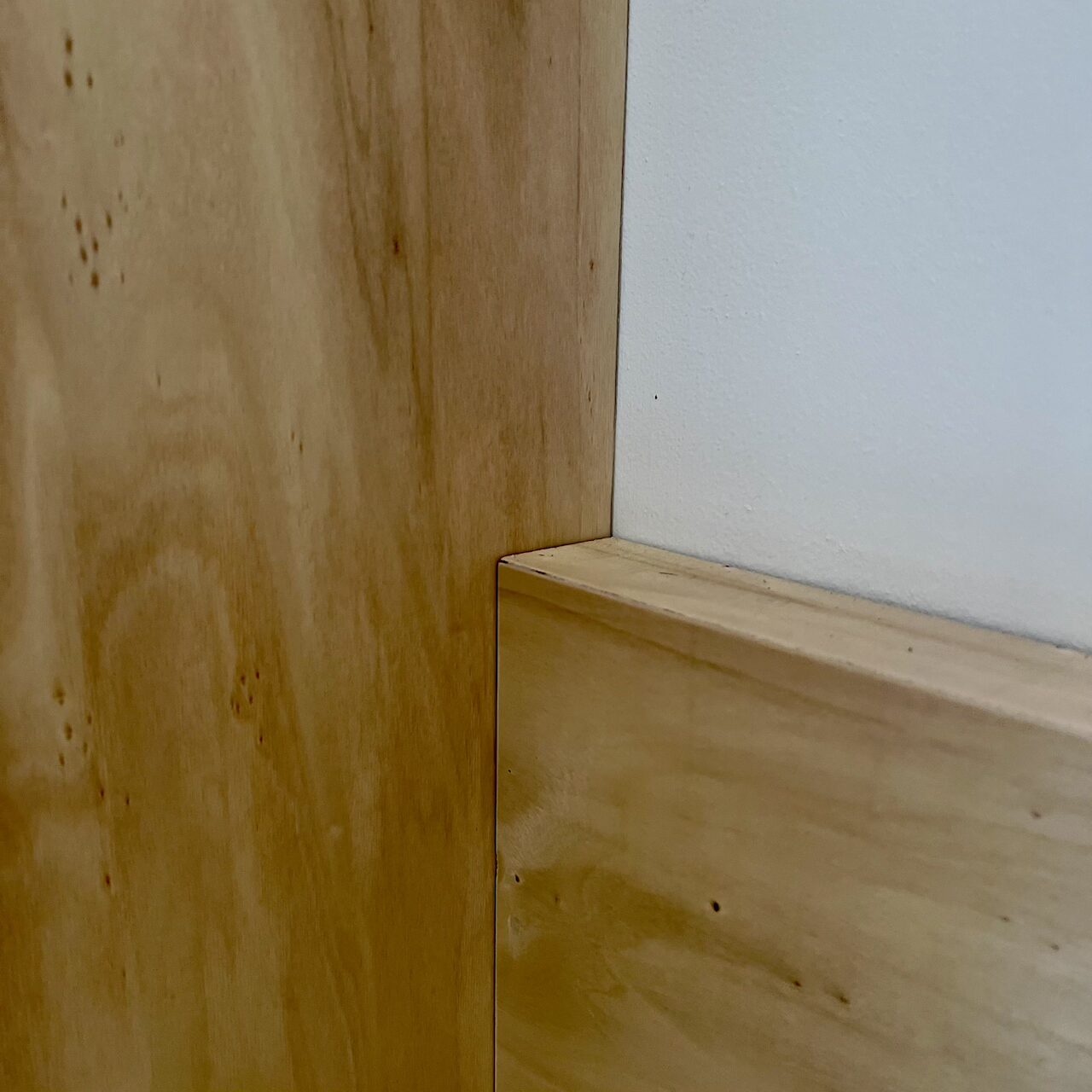 Zoom sur l’angle de la banquette en contreplaqué dans un loft nantais